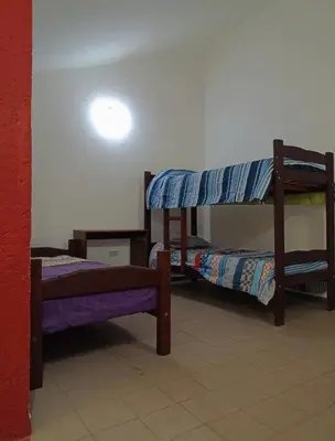 a room with three bunk beds in a room at Alojamiento Quilo in Merlo