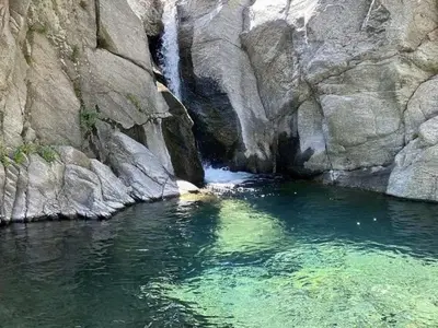 a river with a waterfall in a rocky canyon at Alojamiento Quilo in Merlo