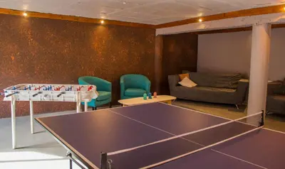 a living room with a ping pong table and chairs at Realty vacacional 61 in Villa Carlos Paz