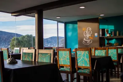 a dining room with a table and chairs with a view at Realty vacacional 61 in Villa Carlos Paz