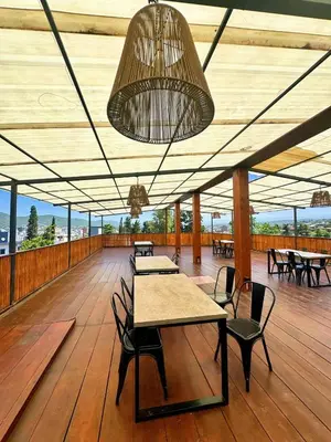 a pavilion with tables and chairs on a wooden floor at Realty vacacional 61 in Villa Carlos Paz