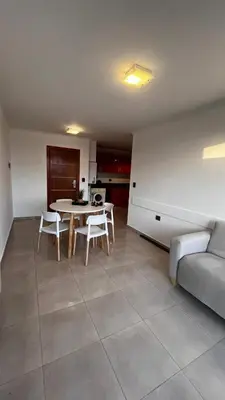 a living room with a table and chairs and a couch at Dto con pileta en Carlos Paz 28! in La Cuesta