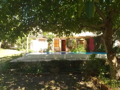 a small house with a tree in front of it at Los Nogales in Los Hornillos