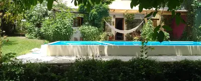 a swimming pool in front of a house at Los Nogales in Los Hornillos