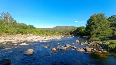 a river with rocks and trees on the side at Rincón del Descanso in San Antonio de Arredondo