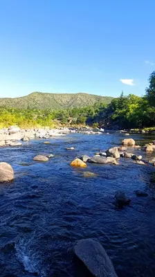 a river with rocks in the middle of it at Rincón del Descanso in San Antonio de Arredondo