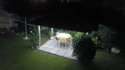a table and chairs in a backyard at night at Rincón del Descanso in San Antonio de Arredondo