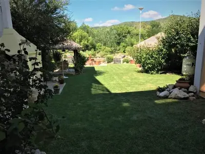 a yard with green grass and a gazebo at Rincón del Descanso in San Antonio de Arredondo
