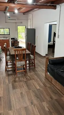 a kitchen and dining room with a table and chairs at Cabañas Valle de Anisacate 4 in Villa Anizacate