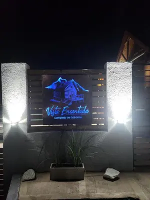 a sign on the side of a wall with lights at Vista Encantada Complejo in Villa Carlos Paz