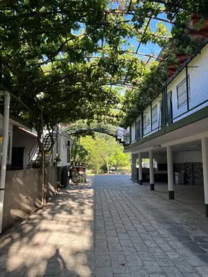 an empty street with trees in the middle of a building at Departamento en Complejo Panaholma in Villa Cura Brochero