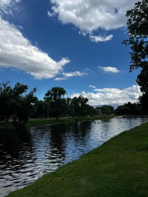 a river with a blue sky and clouds at Departamento en Complejo Panaholma in Villa Cura Brochero