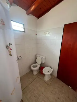 a bathroom with a toilet and a sink at Departamento en Complejo Panaholma in Villa Cura Brochero
