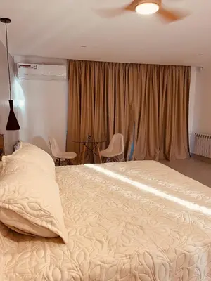 a bedroom with a large bed and a window at Bellamontagna Suites in Mina Clavero