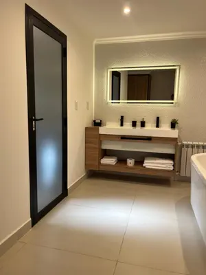 a bathroom with a sink and a mirror at Bellamontagna Suites in Mina Clavero