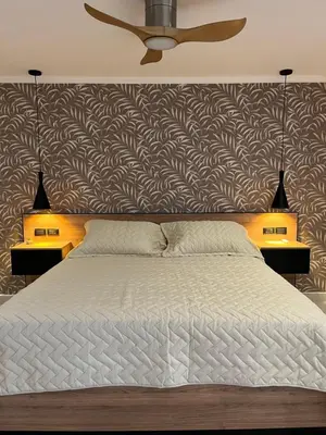 a bedroom with a large bed with two night stands at Bellamontagna Suites in Mina Clavero
