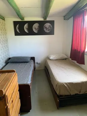 two twin beds in a room with planets on the wall at La Roca in Estancia Vieja