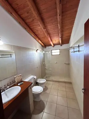a bathroom with two toilets and a sink at Cabaña Alamo in Mina Clavero