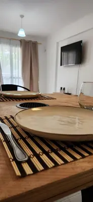 a wooden table with two plates on top of it at Gama Villasol Temporario in Cordoba