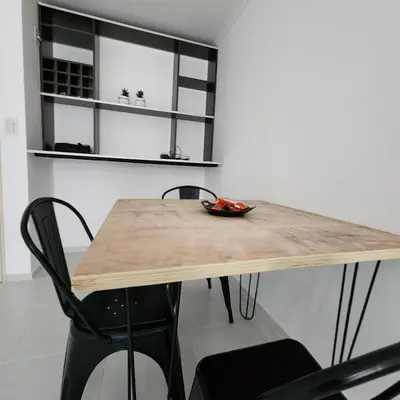 a dining room table with two chairs and a wooden top at Gama Villasol Temporario in Cordoba