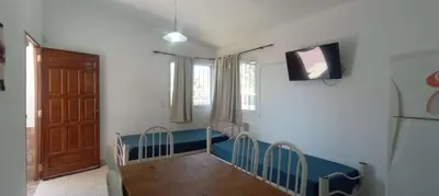 a dining room with a table and chairs and a television at Nuevos Aires de San Antonio in San Antonio de Arredondo