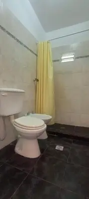 a bathroom with a toilet and a yellow shower at Nuevos Aires de San Antonio in San Antonio de Arredondo