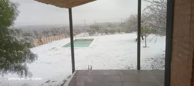 a view of a snow covered yard with a swimming pool at Los Chivos in Villa Cura Brochero