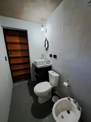 a bathroom with a toilet and a sink at Los Chivos in Villa Cura Brochero