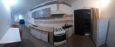 a kitchen with a stove and a refrigerator at Cabañas cochico in Villa Carlos Paz