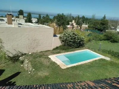 a swimming pool in the yard of a house at Casa en Rumipal de 4 a 11 personas in Villa Rumipal