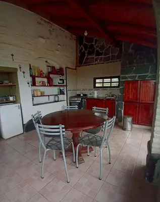 a kitchen with a table and chairs in a kitchen at Casa en Rumipal de 4 a 11 personas in Villa Rumipal