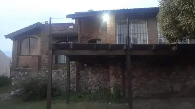 a brick house with a light on top of it at Casa en Rumipal de 4 a 11 personas in Villa Rumipal