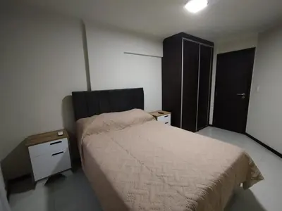 a small bedroom with a bed and a cabinet at Departamento MIRALEJOS 14 in Villa Carlos Paz