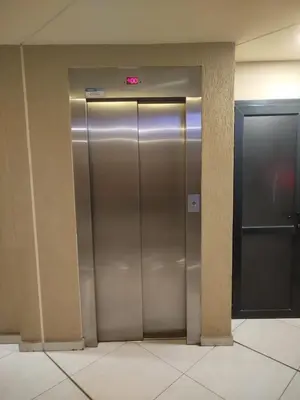 a metal elevator in a building with a sign on it at Departamento MIRALEJOS 14 in Villa Carlos Paz