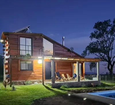 a small wooden house with a pool at Ullasa - Casa de Montaña in Villa Yacanto