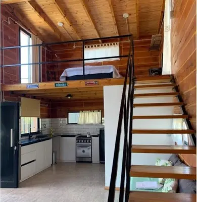 a staircase leading up to the kitchen of a tiny house at Ullasa - Casa de Montaña in Villa Yacanto