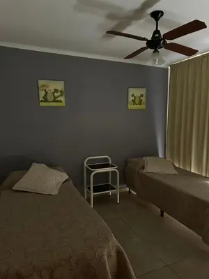 a bedroom with a bed and a ceiling fan at Ayres de las Sierras Villa Carlos Paz in Villa Carlos Paz