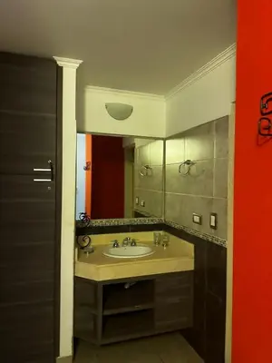 a bathroom with a sink and a mirror at Ayres de las Sierras Villa Carlos Paz in Villa Carlos Paz