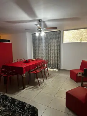 a dining room with a red table and chairs at Ayres de las Sierras Villa Carlos Paz in Villa Carlos Paz