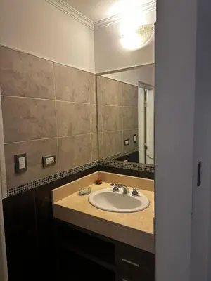 a bathroom with a sink and a mirror at Ayres de las Sierras Villa Carlos Paz in Villa Carlos Paz