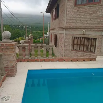 a house with a blue swimming pool in the yard at Mis 4 Soles in Santa María