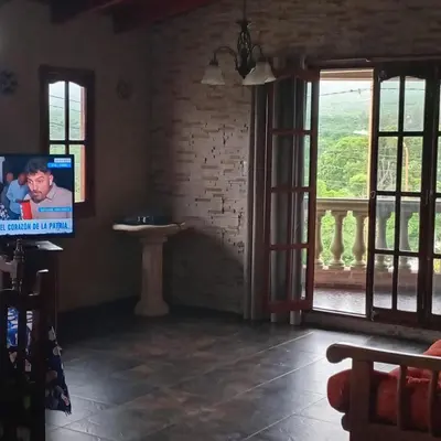 a living room with a tv and an open door at Mis 4 Soles in Santa María