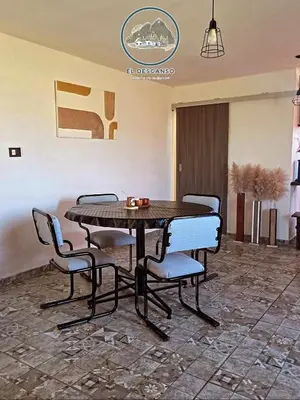 a wooden table and chairs in a room at El descanso casita en alquiler in Taninga