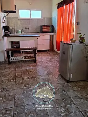a kitchen with a sink and a refrigerator in a room at El descanso casita en alquiler in Taninga