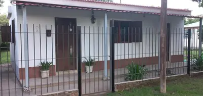 a house with a fence and potted plants at La casa de Los Abuelos in La Bolsa