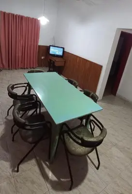 a green table and chairs in a room at La casa de Los Abuelos in La Bolsa