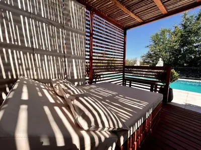a bed sitting on a deck next to a pool at Carpe Diem Cabañas en Panaholma in Panaholma
