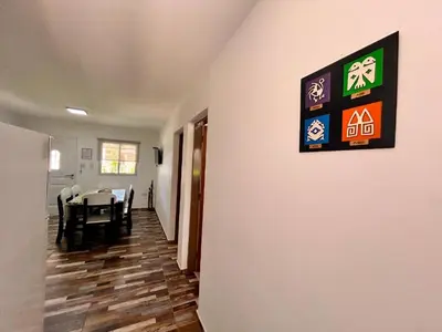 a dining room with a table and a sign on the wall at Carpe Diem Cabañas en Panaholma in Panaholma