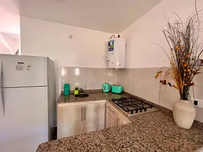 a kitchen with a stove and a white refrigerator at Carpe Diem Cabañas en Panaholma in Panaholma