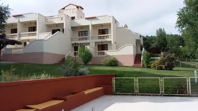 a large house with a fence in front of it at El Cabañal in Mina Clavero